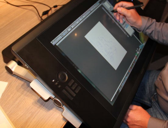 Person using a Wacom Cintiq 24HD graphics tablet.